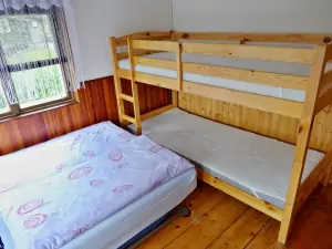 ložnice s rozkládacím gaučem pro 2 osoby a patrovou postelí