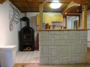 kuchyňský kout a krbová kamna v obytném pokoji