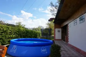 zahradní kruhový bazén (průměr 3,6 m) a za ním trampolína