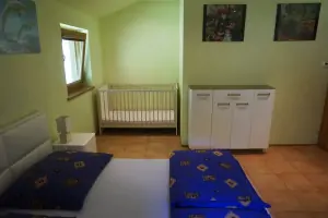 dětská postýlka v ložnici s dvojlůžkem v přízemí