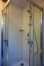 koupelna se sprchovým koutem a umyvadlem v podkroví