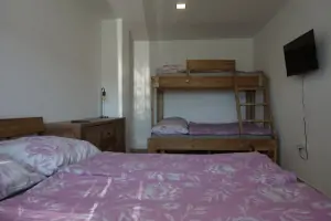 ložnice s dvojlůžkem a patrovou postelí pro 3 osoby