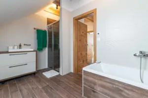 koupelna s vanou, sprchovým koutem, umyvadlem a WC v podkroví