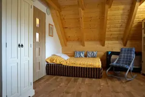 ložnice s dvojlůžkem, lůžkem a dětskou postýlkou v podkroví
