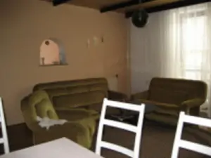 Obytná místnost je vybavena sedací soupravou, jídelním koutem a TV+SAT