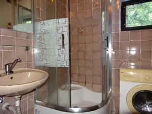 koupelna je vybavena sprchovým koutem, umyvadlem a pračkou